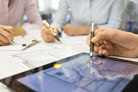 image of people at a desk working on test results